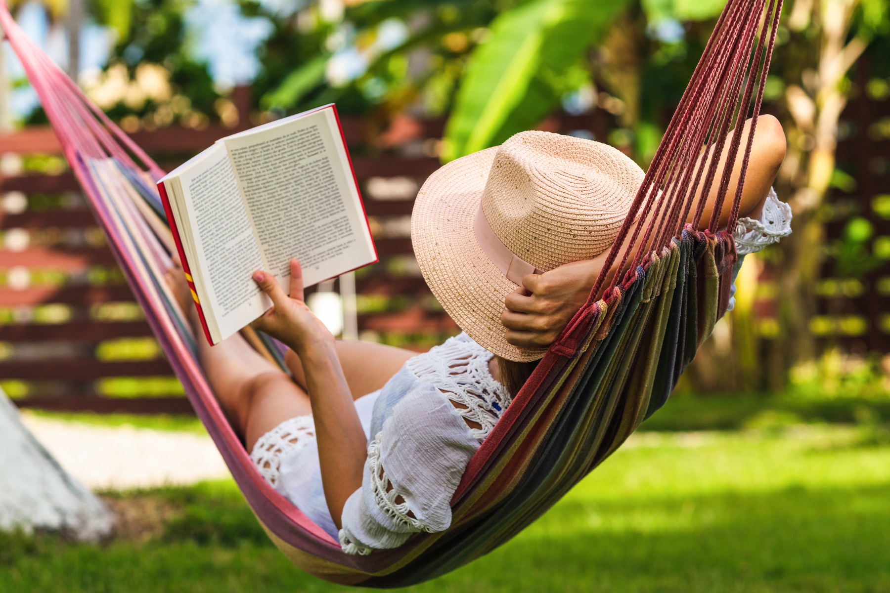 Woman reading book in hammock